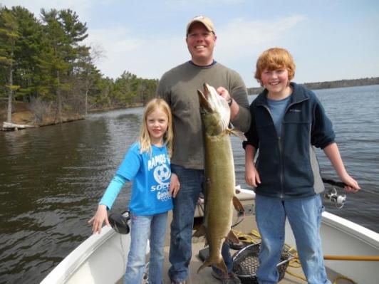 father with kids fishing